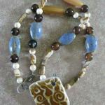 #011 BUTTERSCOTCH SWIRL Necklace made with pottery pendant with swirls that look like butterscotch! Complimented by blue pottery beads and picture jasper. Clasp and pendant are sterling silver with a nice patina for an aged look. 18"  Sale! $40