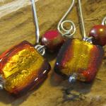 #019 Dichroic glass of red and gold combine with a czech red and gold bead to complete this stunning pair of earrings. The pair is finished off with handmade sterling silver ear wires. 2 3/8" long from top of ear wire to bottom of glass bead. SOLD
